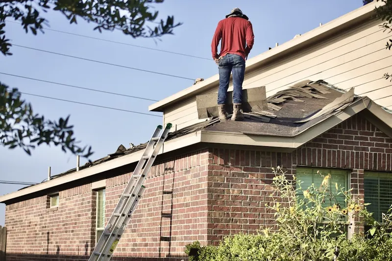 Professional roofer working on a residential roof in Sherwood Manor